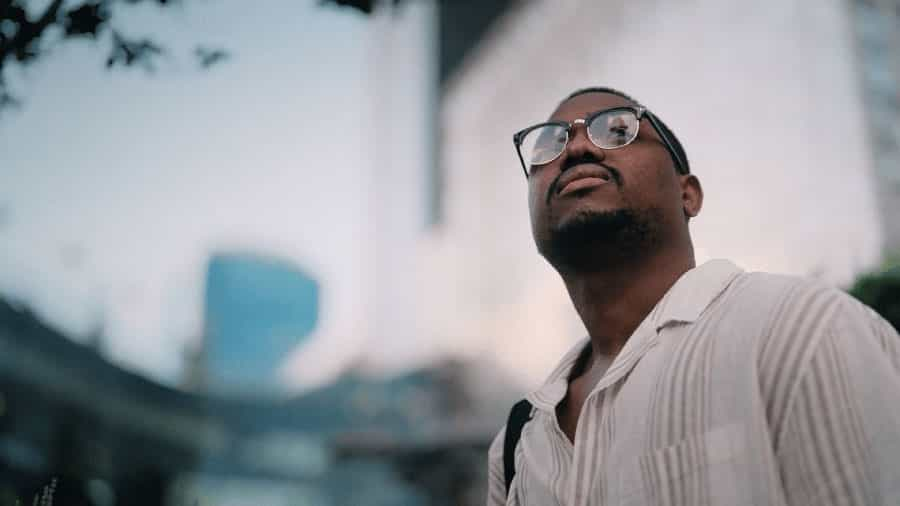 person looking upwards with commercial properties in the background